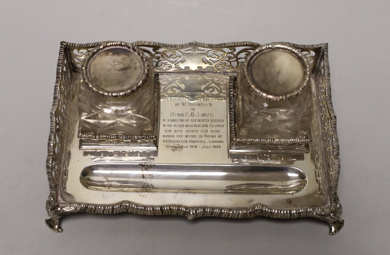 A George V pierced silver rectangular inkstand, with two mounted glass bottles and pen recess, Goldsmiths & Silversmiths Co Ltd, London, 1925, 19.5cm, 12.7oz.